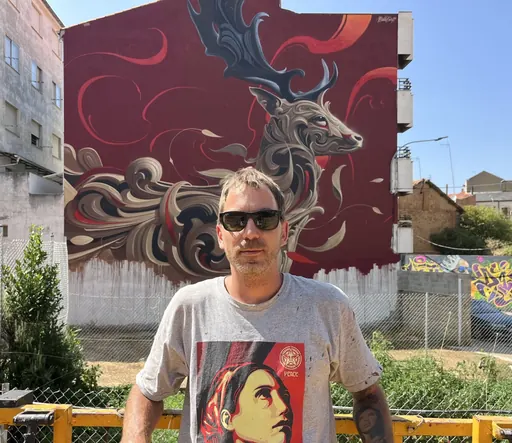 Bublegum standing in front of a mural