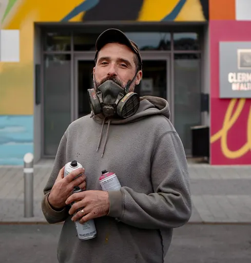 Omin holding spray cans