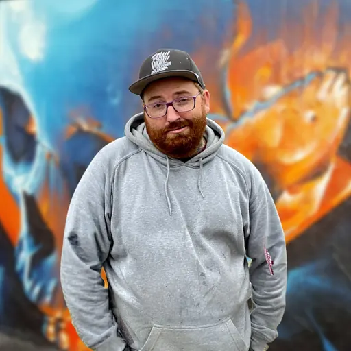 Smug standing in front of a mural