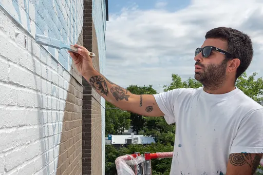 Tellas painting a wall