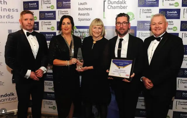 Five attendees holding an award and certificate at the Louth Business Awards